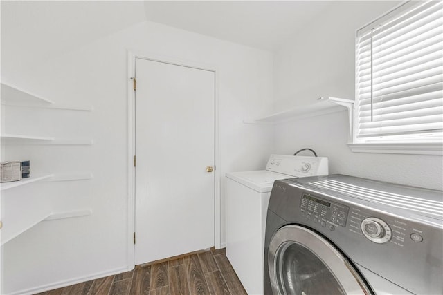 laundry area with washer and clothes dryer and dark wood-type flooring