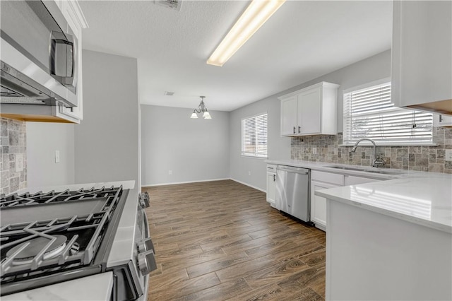 kitchen featuring a wealth of natural light, white cabinetry, and stainless steel appliances