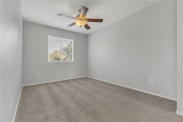 carpeted spare room featuring ceiling fan