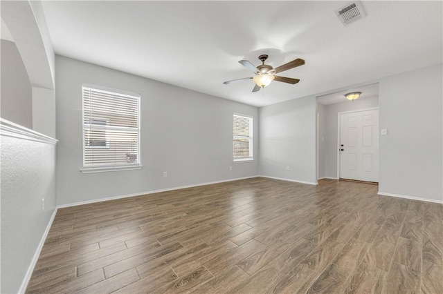 empty room with hardwood / wood-style flooring and ceiling fan