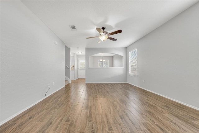 spare room featuring wood-type flooring, ceiling fan, and a healthy amount of sunlight