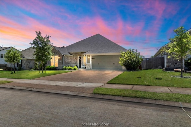 view of front facade with a yard and a garage