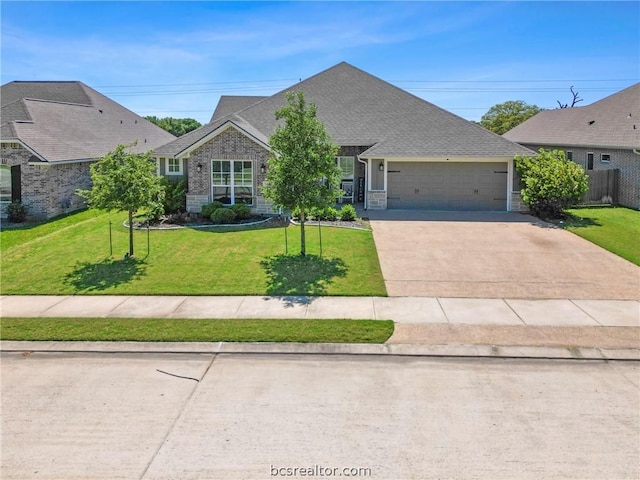 view of front of home with a garage and a front lawn