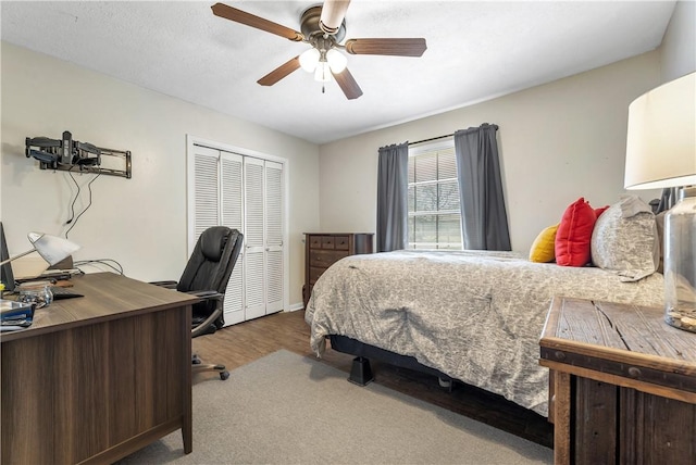 bedroom with wood-type flooring, a closet, and ceiling fan