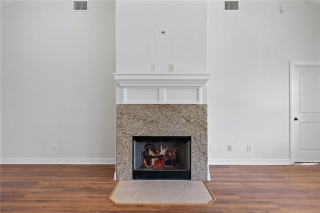 4412 Hearst Ct, College Station, TX 77845 - detailed view of wood finished floors, baseboards, and a fireplace
