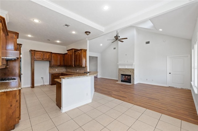 4412 Hearst Ct, College Station, TX 77845 - kitchen featuring light tile patterned flooring, backsplash, ceiling fan, light stone countertops, and recessed lighting