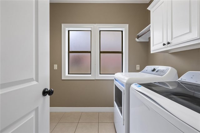 4412 Hearst Ct, College Station, TX 77845 - laundry room featuring washer and clothes dryer, cabinet space, baseboards, and light tile patterned flooring