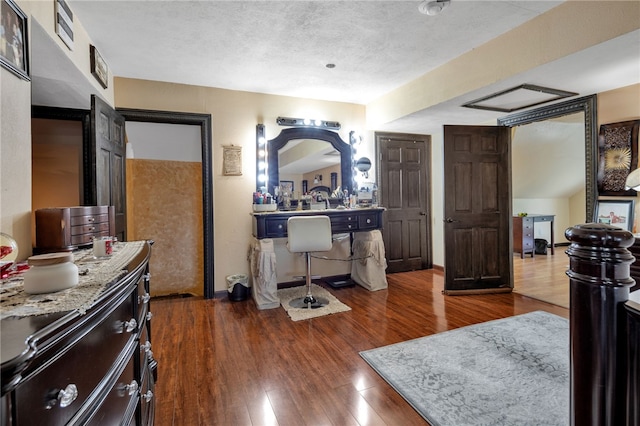 bedroom featuring dark hardwood / wood-style floors and a textured ceiling