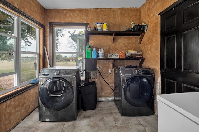 laundry area featuring light tile patterned flooring and washer and dryer