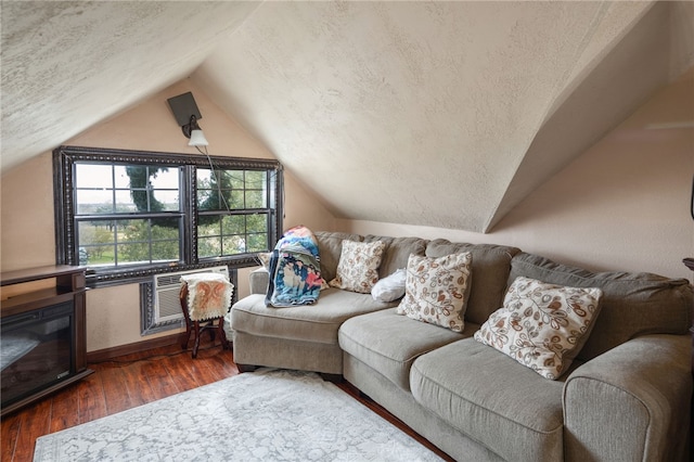 living room with vaulted ceiling, dark hardwood / wood-style floors, and a textured ceiling