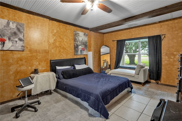 tiled bedroom with ceiling fan and beam ceiling