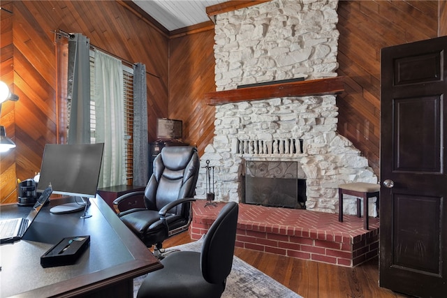 office featuring hardwood / wood-style flooring, a fireplace, and wooden walls