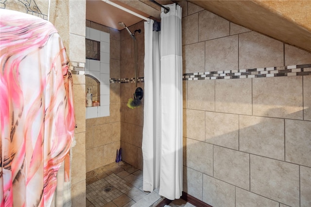 bathroom featuring lofted ceiling and walk in shower