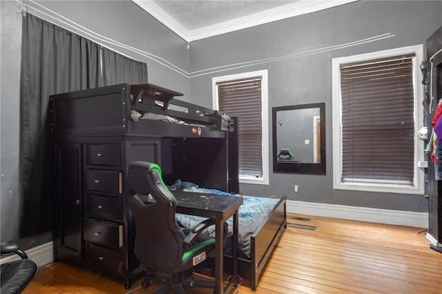 bedroom featuring ornamental molding and wood-type flooring