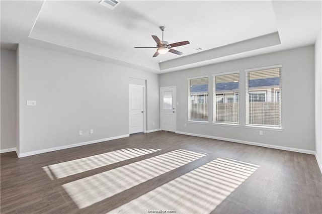 5769 Paseo Pl, Bryan, TX 77807 - empty room featuring a raised ceiling, a ceiling fan, and wood finished floors