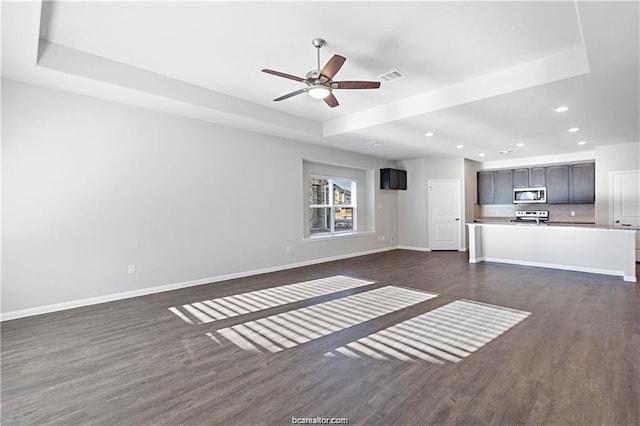 5769 Paseo Pl, Bryan, TX 77807 - unfurnished living room featuring dark wood finished floors, a ceiling fan, and recessed lighting
