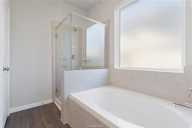 5769 Paseo Pl, Bryan, TX 77807 - bathroom featuring a garden tub, a shower stall, and wood finished floors