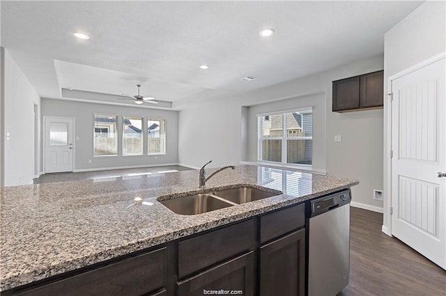 5769 Paseo Pl, Bryan, TX 77807 - kitchen featuring dishwasher, dark brown cabinets, light stone countertops, a tray ceiling, and recessed lighting