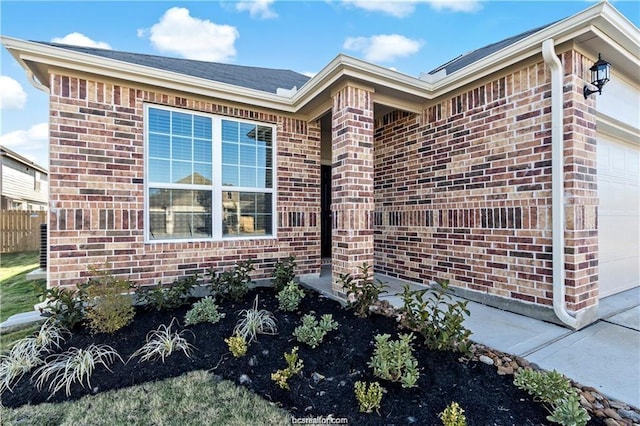 5769 Paseo Pl, Bryan, TX 77807 - view of home's exterior with a garage and brick siding