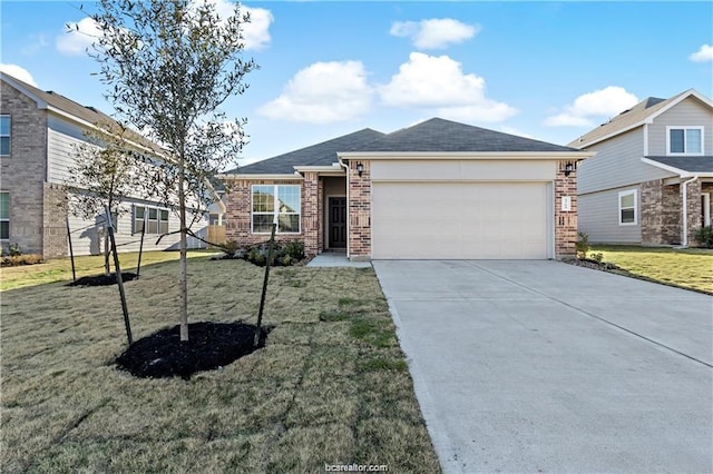 5769 Paseo Pl, Bryan, TX 77807 - view of front of house featuring brick siding, a garage, driveway, and a front lawn