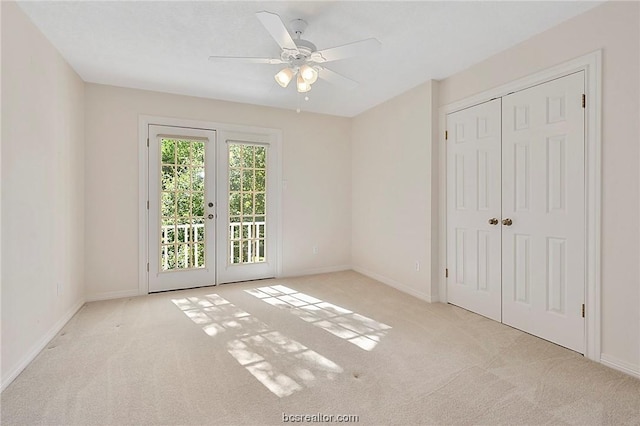 unfurnished bedroom with ceiling fan, french doors, access to outside, light carpet, and a closet