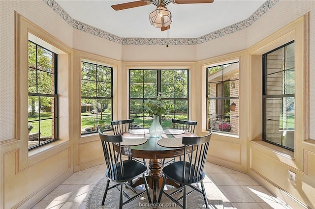 sunroom / solarium featuring ceiling fan and a wealth of natural light