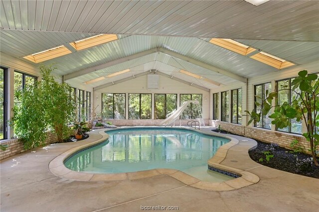 view of pool with a water slide and a skylight