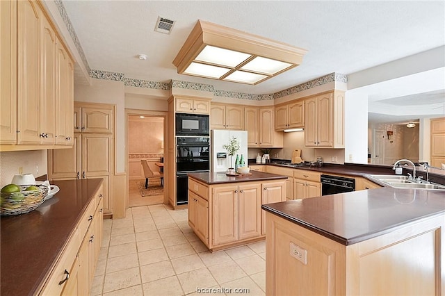 kitchen with light brown cabinetry, sink, a center island, and black appliances