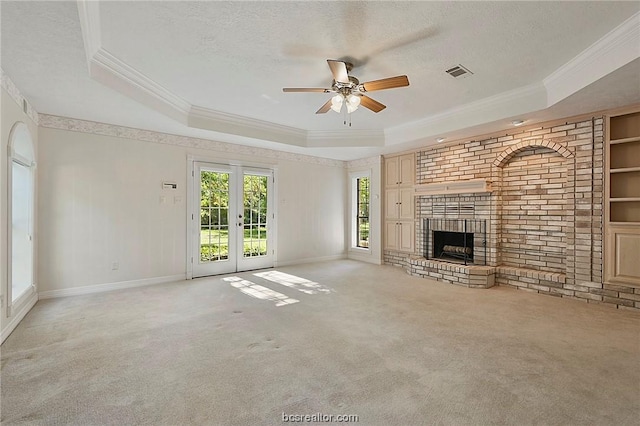 unfurnished living room featuring light colored carpet and a tray ceiling