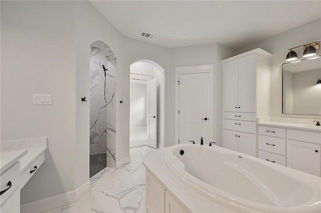 7888 Mathis Creek Dr, Bryan, TX 77808 - bathroom featuring marble look tiles, a marble finish shower, vanity, and a garden tub
