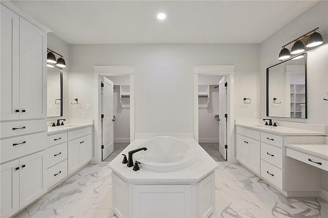 7888 Mathis Creek Dr, Bryan, TX 77808 - full bathroom with marble finish floors, a walk in closet, two vanities, a garden tub, and recessed lighting