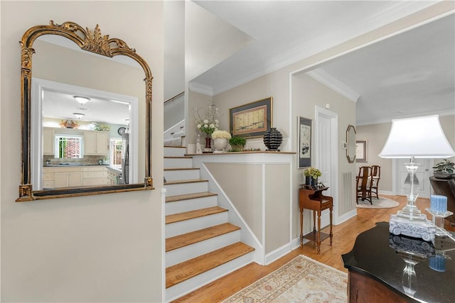 staircase featuring ornamental molding and wood-type flooring