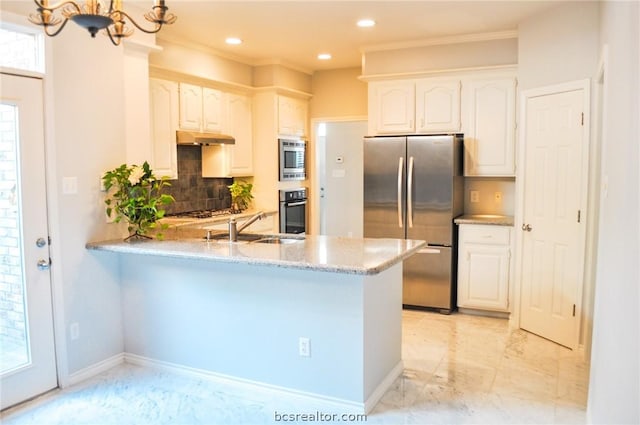 kitchen featuring backsplash, white cabinetry, sink, and appliances with stainless steel finishes