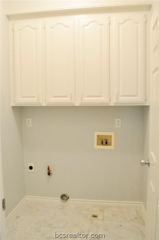 washroom featuring cabinets, washer hookup, hookup for a gas dryer, and electric dryer hookup