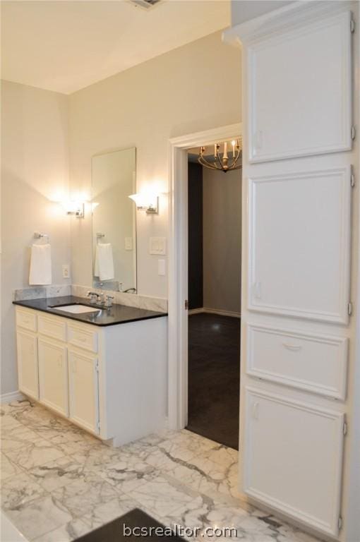 bathroom with vanity and an inviting chandelier