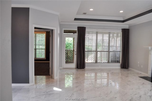 entrance foyer featuring a raised ceiling and ornamental molding