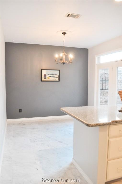 kitchen with a chandelier and decorative light fixtures