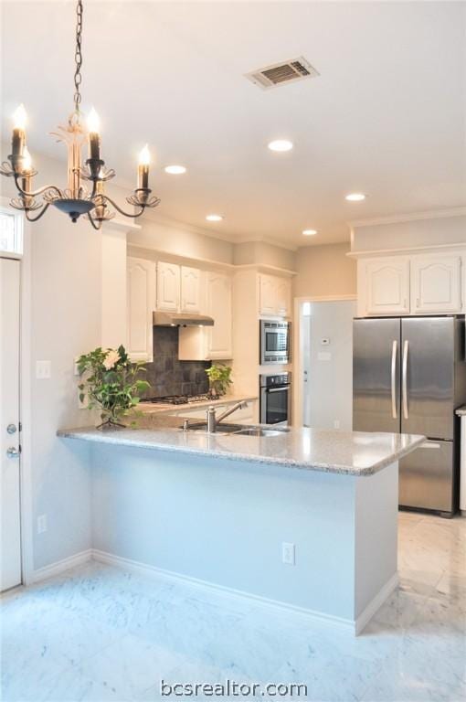 kitchen featuring backsplash, white cabinets, decorative light fixtures, kitchen peninsula, and stainless steel appliances