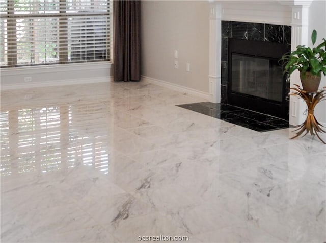 unfurnished living room featuring a high end fireplace