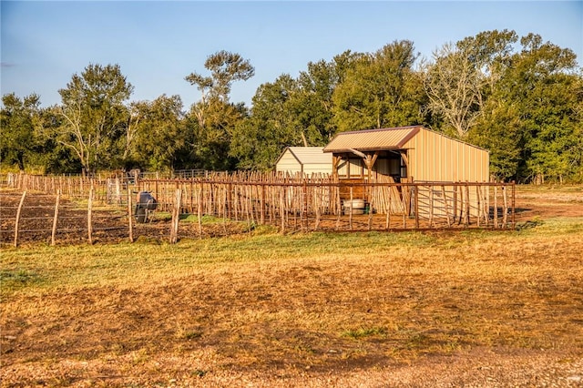 view of yard featuring a rural view and an outdoor structure