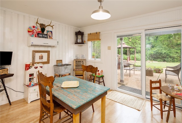 803 Meadow Ln, Bryan, TX 77802 - dining space with light wood-type flooring and a wall unit AC