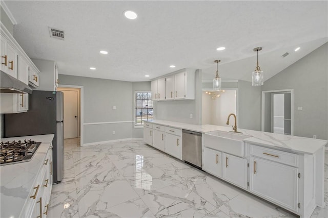 kitchen featuring visible vents, appliances with stainless steel finishes, decorative light fixtures, white cabinetry, and a sink