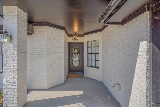 entrance to property featuring brick siding