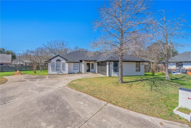 ranch-style house featuring an attached garage, driveway, a front yard, and fence