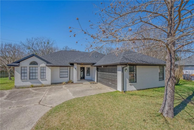 view of front facade featuring brick siding, a shingled roof, concrete driveway, an attached garage, and a front lawn