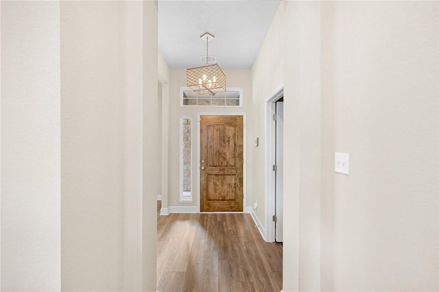 4842 Native Tree Ln, College Station, TX 77845 - entryway featuring wood finished floors, a chandelier, and baseboards