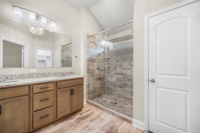 4842 Native Tree Ln, College Station, TX 77845 - bathroom with a stall shower, double vanity, and wood finished floors