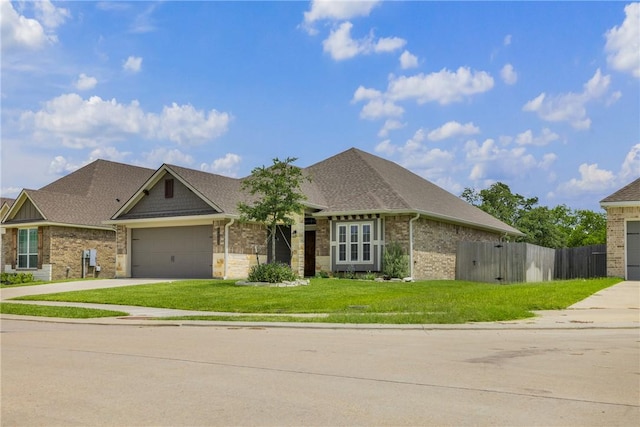 4842 Native Tree Ln, College Station, TX 77845 - view of front of home featuring a garage, concrete driveway, brick siding, and roof with shingles