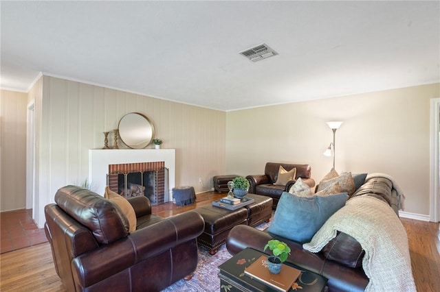 1210 Munson Ave, College Station, TX 77840 - living room featuring ornamental molding, wood finished floors, a fireplace, and baseboards