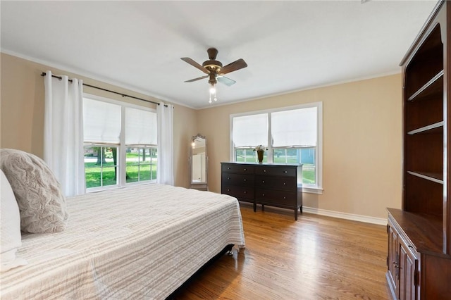 1210 Munson Ave, College Station, TX 77840 - bedroom featuring multiple windows, wood finished floors, crown molding, baseboards, and a ceiling fan